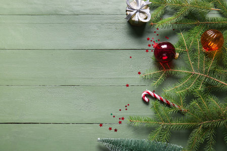 Composition with fir branches and Christmas decorations on green wooden backgroundの写真素材