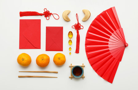 Envelopes with mandarins, fortune cookies and Chinese symbols on white background. New Year celebrationの写真素材