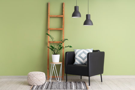 Interior of living room with wooden ladder, armchair and poufの写真素材