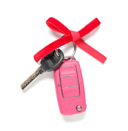 Gift keys of new car with red bow on white backgroundの写真素材