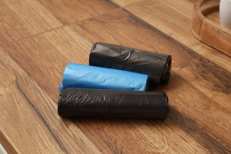 Rolls of garbage bags on floor in kitchenの写真素材