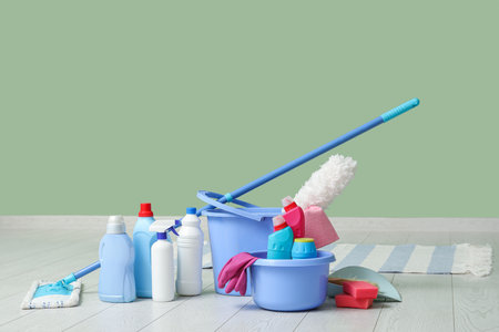 Different cleaning supplies on floor at homeの写真素材