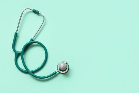 Stethoscope with Christmas ball on green backgroundの写真素材