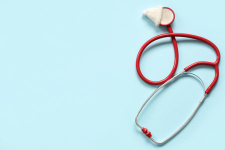Stethoscope with decorative Christmas hat on blue backgroundの写真素材