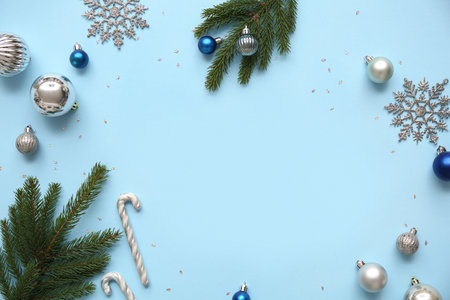Fir tree branches and Christmas decor on blue background. Top viewの写真素材