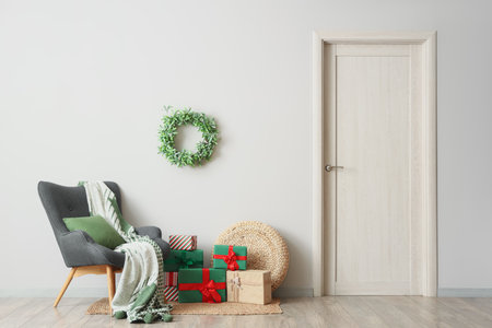 Interior of room with armchair, Christmas mistletoe wreath and presentsの写真素材
