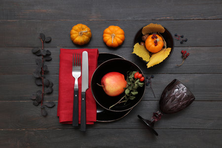 Stylish autumn table setting with pumpkins on dark wooden backgroundの写真素材