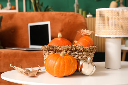 Coffee table with pumpkin in basket and lamp in living room. Closeupの写真素材