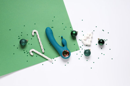 Composition with vibrator and beautiful Christmas decor on color background