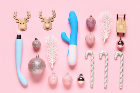 Composition with vibrators and beautiful Christmas decorations on pink backgroundの写真素材