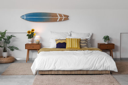 Beautiful sunflowers on beside table in interior of cozy bedroomの写真素材