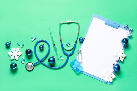Composition with stethoscope, medicines, blank clipboard and Christmas decorations on color backgroundの写真素材