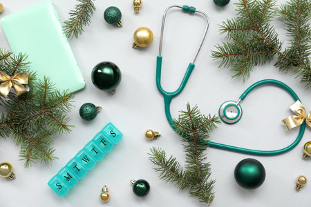Composition with medical supplies, Christmas decorations and fir branches on gray backgroundの写真素材