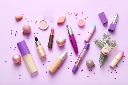 Composition with decorative cosmetics and Christmas decorations on lilac backgroundの写真素材