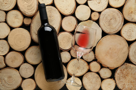 Bottle of red wine and glass on wooden backgroundの写真素材