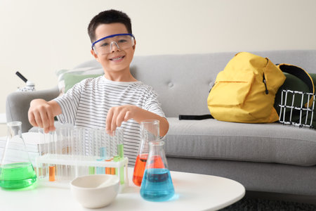 Cute little boy with chemistry flasks at homeの写真素材