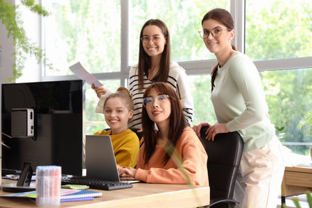 Group of female programmers working at table in officeの写真素材