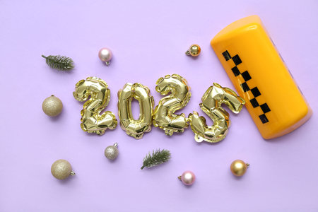 Figure 2025 with taxi roof sign and Christmas balls on lilac background