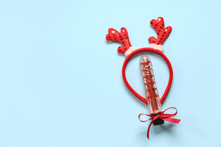Vibrator and reindeer horns headband on color backgroundの写真素材