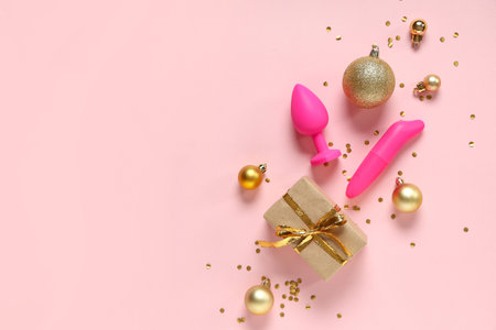 Composition with sex toys, beautiful Christmas decorations and gift on pink backgroundの写真素材