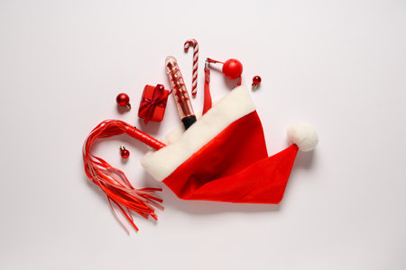 Composition with Santa hat, sex toys and Christmas decorations on white backgroundの写真素材