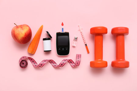 Glucometer with lancet pen, food and dumbbells on pink background. Diabetes conceptの写真素材