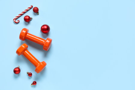 Composition with dumbbells and Christmas decorations on color backgroundの写真素材