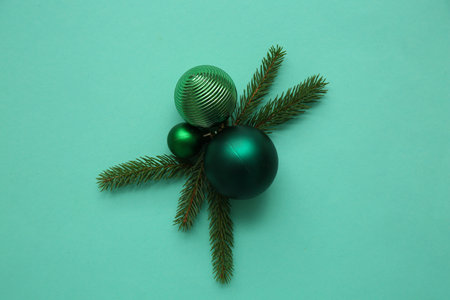 Composition with fir tree branches and Christmas balls on turquoise background. Top viewの写真素材