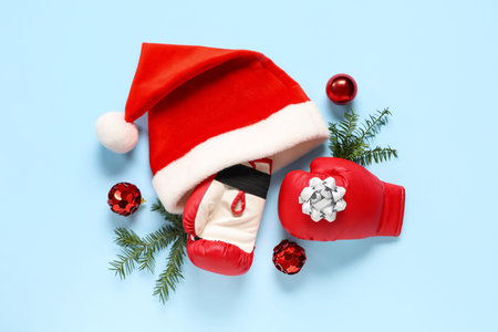 Composition with boxing gloves, Santa hat and Christmas decorations on color backgroundの写真素材