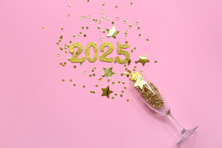 Figure 2025, glass and glitters on pink background. New Year celebration
