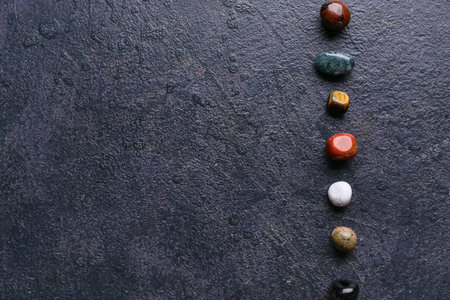Set of chakra stones on dark background