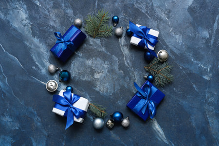 Gifts and Christmas decorations on blue background with space for textの写真素材