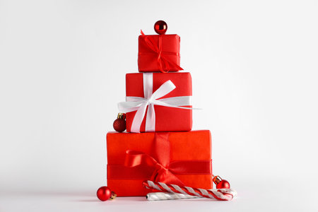 Christmas gift boxes with balls and candy cane toys on white backgroundの写真素材