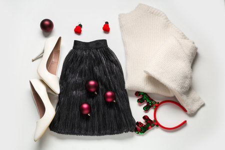 Composition with stylish clothes, shoes and Christmas decorations on white backgroundの写真素材