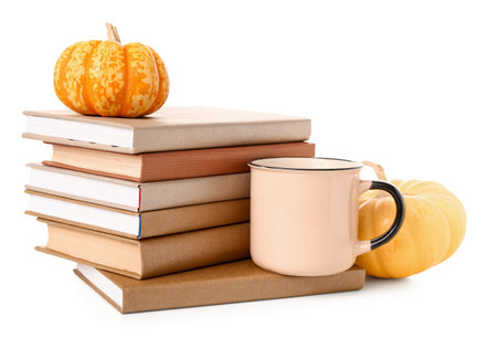 Different books, cup of tea and pumpkins on white backgroundの写真素材