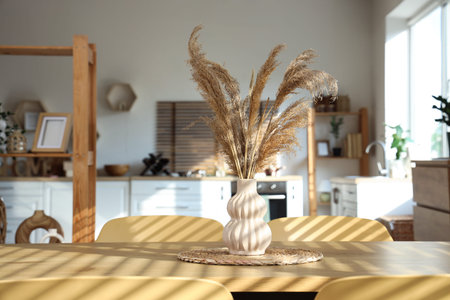 Vase on dining table in light modern kitchenの写真素材