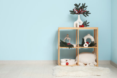 Shelving unit with Christmas decoration near blue wallの写真素材