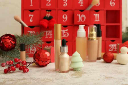 Different cosmetic products, advent calendar and Christmas decor on tableの写真素材