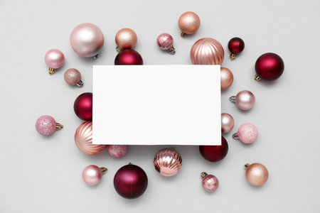 Blank card and Christmas balls on white backgroundの写真素材