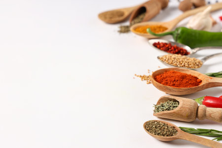 Spoons and scoops with fresh aromatic spices on gray backgroundの写真素材