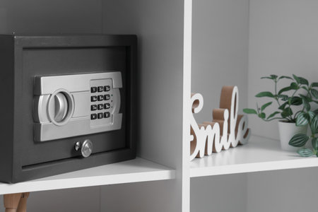 Modern safe on shelf in room, closeupの写真素材