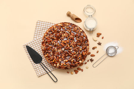 Sweet tart with different nuts and ingredients on beige backgroundの写真素材
