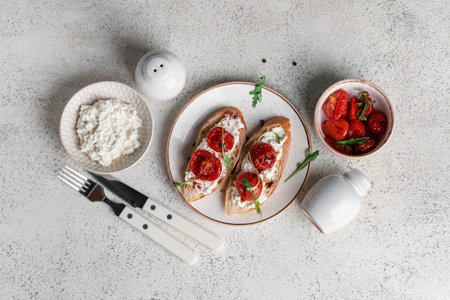 Plate of tasty tomato bruschetta with ricotta on white backgroundの写真素材