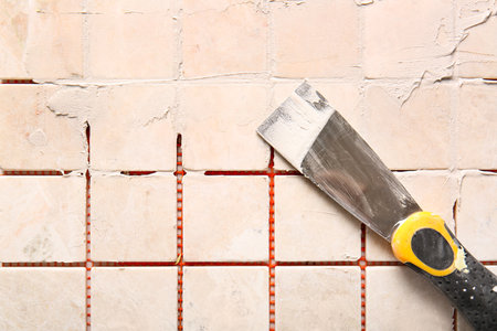 Knife with putty on tiles, top viewの写真素材