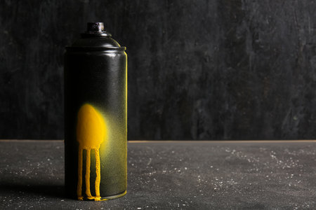Spray paint can on black tableの写真素材