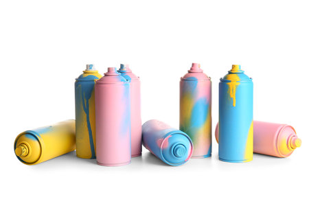Different spray paint cans on white background