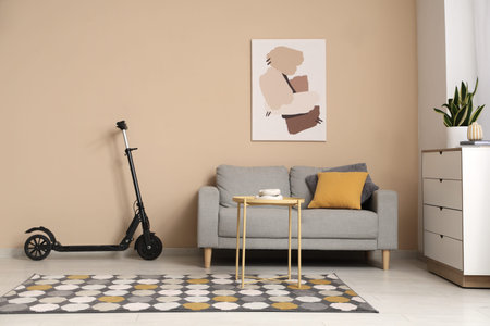 Interior of living room with electric scooter, sofa and table