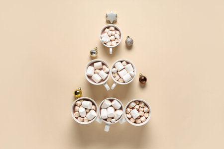 Christmas tree made of cups with tasty cocoa drink on color background