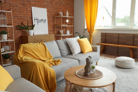 Interior of living room with cozy sofas, coffee table and pouf
