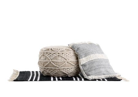 Pouf and pillow on rug on white backgroundの写真素材